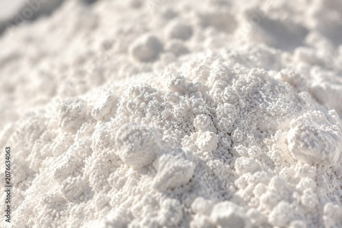 Close-up of fine white diatomaceous earth showing porous texture in natural light.