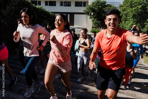 Group of latin people running and training together in mexican street in Mexico Latin America, hispanic runners club preparing a race