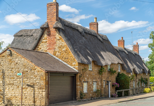 Photos Sunlit Thatched Cottages With Stone Walls and Brick Chimneys in Picturesque Engl