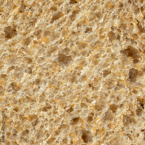 Full frame view of fresh baked porous rye bread structure close-up