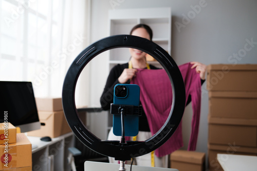 Woman selling clothes livestreaming products for small business