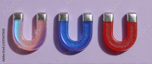 Three horseshoe magnets in different colors on a light purple background.