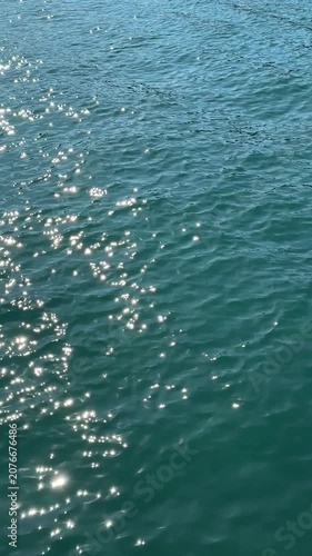 Sparkling sea water with gentle ripples vertical video.