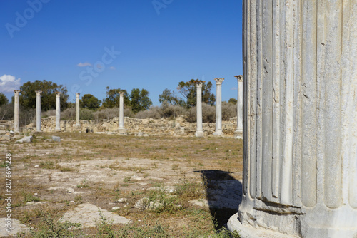 Ancient ruins of Salamis, North Cyprus feature standing marble columns with Corinthian capitals. The site was once a thriving city and remains an important archaeological and cultural landmark. 