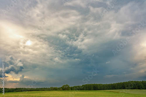 Konstfotografi Dramatic storm clouds over green countryside landscape before rain