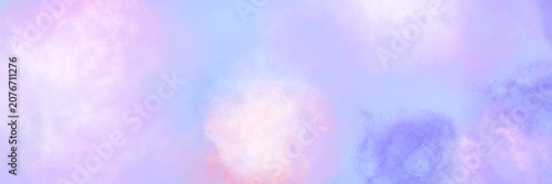 Periwinkle blue and violet watercolor cloudy background. Wide abstract banner featuring a blend of periwinkle blue, violet, and soft white clouds