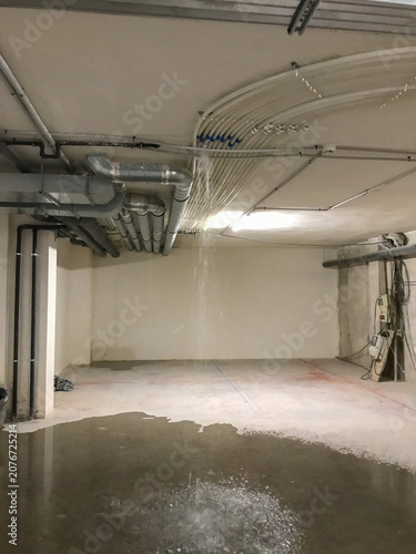 Water leaking from building ceiling causing flood damage