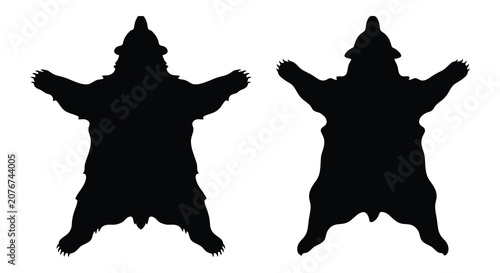 Foto Two black bear skin silhouettes with outstretched paws and heads against a white
