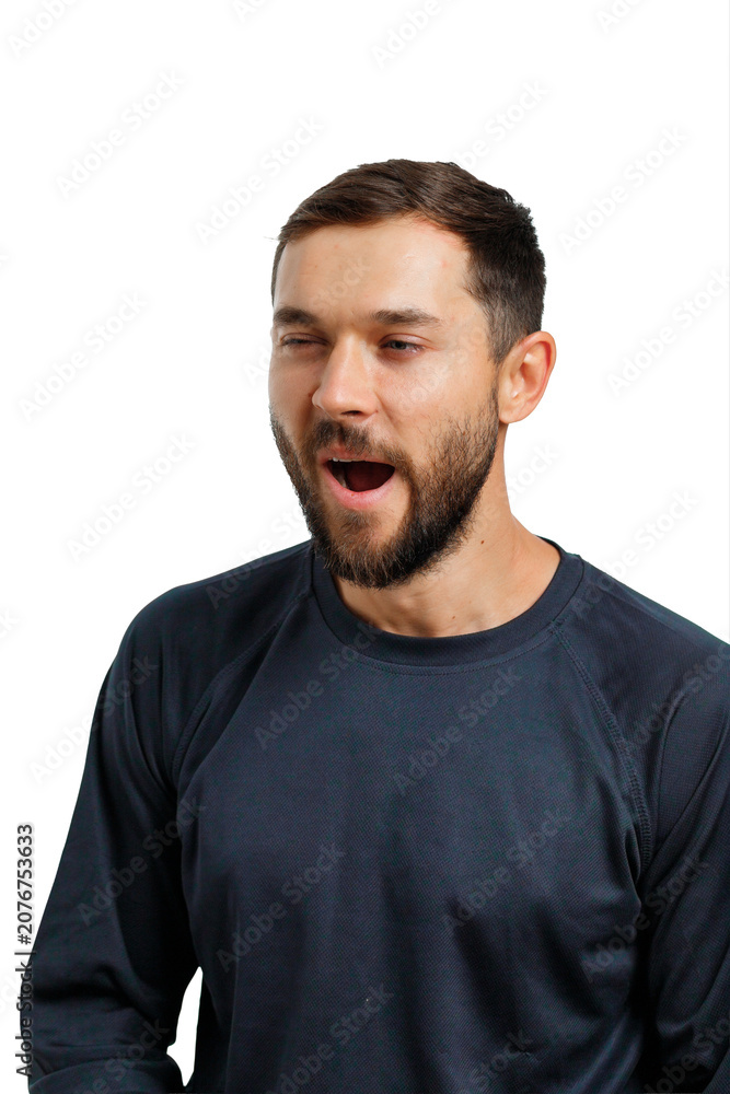 Obraz premium Exhausted young man showing fatigue and yawning