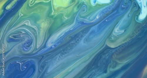 Blue background with unique moving streaks of blue, white, green, lilac tones. Abstract art. Marble texture.