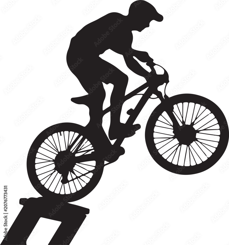 Fototapeta premium Silhouette of a mountain biker performing a jump on a ramp