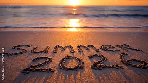 Summer 2026 written on beach sand at sunset with warm cinematic light