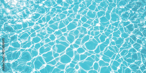 Fényképezés Bright blue swimming pool water surface with sunlight reflections and ripple pat