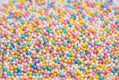 Macro view of dense colorful candy sprinkles and sweet round beads