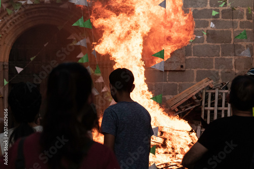 Photos Traditional midsummer bonfire burning brightly outside the historic Church of San Juan Bautista during the Night of San Juan festival in Avila, Castile and Leon, Spain