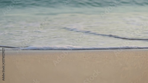 Gentle Ocean Waves Washing onto Sandy Beach Illustrating Tranquility, Relaxation, and Natural Serenity.