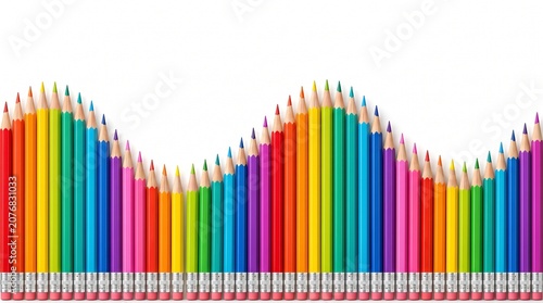 Rainbow colored pencils arranged in a wave pattern