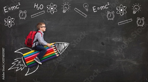 Boy riding pencil rocket on blackboard