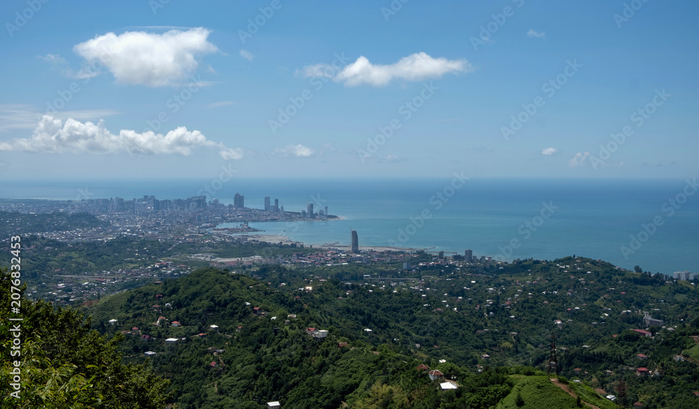 Fototapeta premium High angle panoramic view of Batumi city skyline and the Black Sea coast from the surrounding green hills