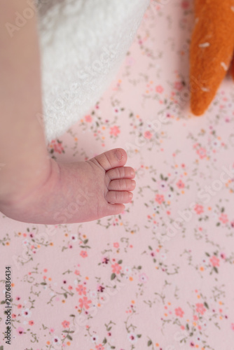 Baby's Foot on Floral Sheet