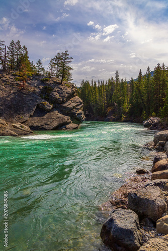 Emerald Waters Flowing Through Kananaskis On A Bright Day