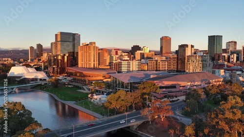 Adelaide City, South Australia – 4K aerial drone footage of CBD skyline, Towers, River Torrens, Convention Centre, Elder Park, city bridges and golden sunset cityscape.