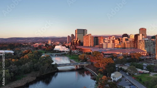 Adelaide City, South Australia – 4K aerial drone footage of CBD skyline, Towers, River Torrens, Convention Centre, Elder Park, city bridges and golden sunset cityscape.