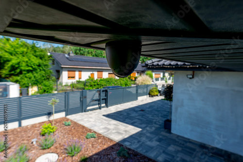 Security dome camera monitoring modern home yard activity