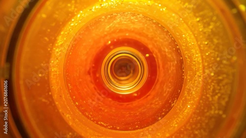 Interior of a cylindrical, illuminated object with concentric, warm-toned rings