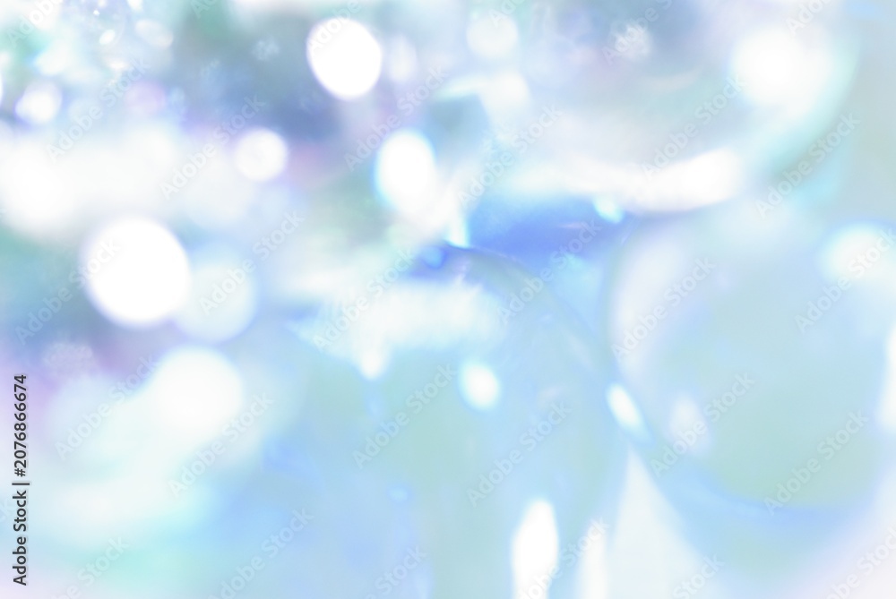 Naklejka premium 水色背景にキラキラ光る抽象的な背景素材