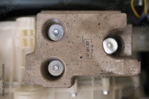 Cuadro en lienzo Closeup of heavy concrete counterweight block with metal bolts inside disassembl