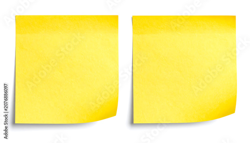 Two square yellow sticky note papers with curled edges for reminders and office communication