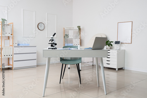 Interior of medical office with doctors desk and shelf units