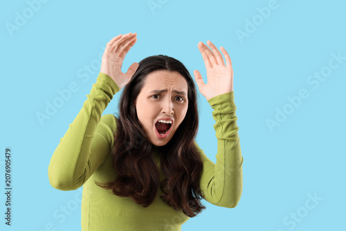 Scared young woman screamin...