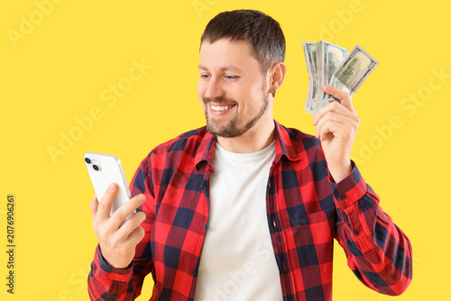 Happy young man with mobile...