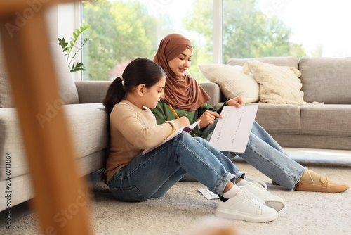 Muslim mother with her litt...