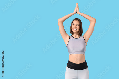 Sporty young woman doing yo...