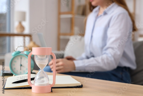 Hourglass and notebook on t...
