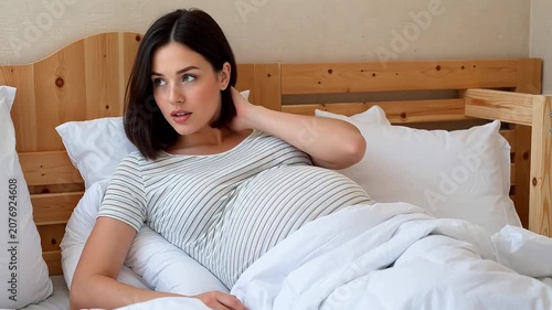 Thoughtful Pregnant Woman Relaxing in Bed