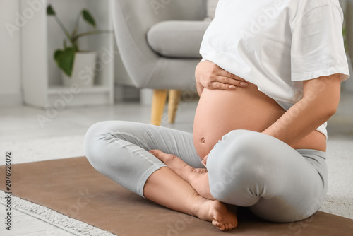 Sporty young pregnant woman...