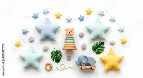 A charming collection of baby nursery decor, including soft star-shaped pillows, a wooden stacking toy, and a cute elephant on wheels, arranged on a white background.