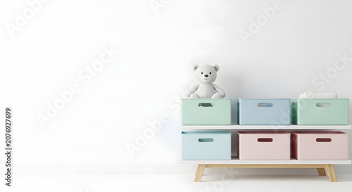 Minimalist nursery or playroom interior with a white teddy bear on pastel storage boxes against a clean white wall.