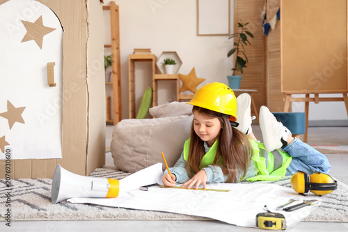 Cute little builder drawing plan at home