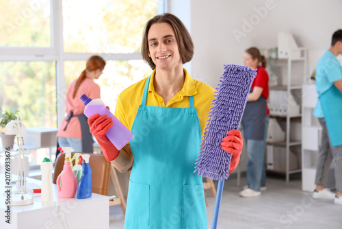 Male janitor with detergent...