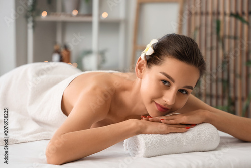 Young woman with plumeria f...