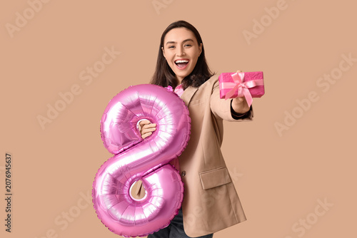 Happy young woman with pink...