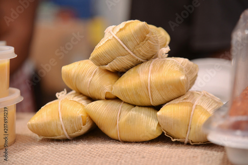 A stack of pamonhas (corn cakes wrapped in husks), a traditional Brazilian food highly popular during the June Festivals (Festas Juninas).