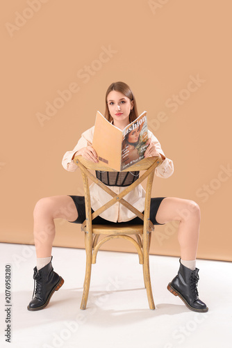 Young woman reading fashion...