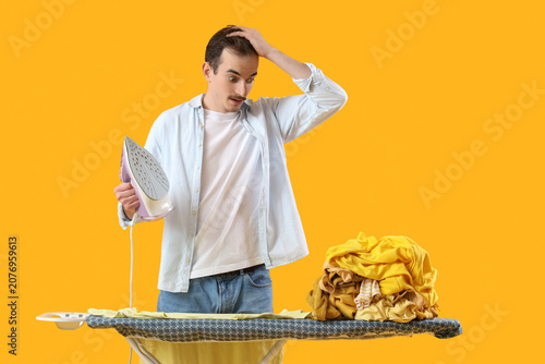 Shocked young man with iron...