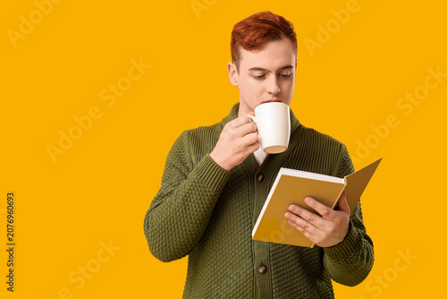 Young man reading book and ...